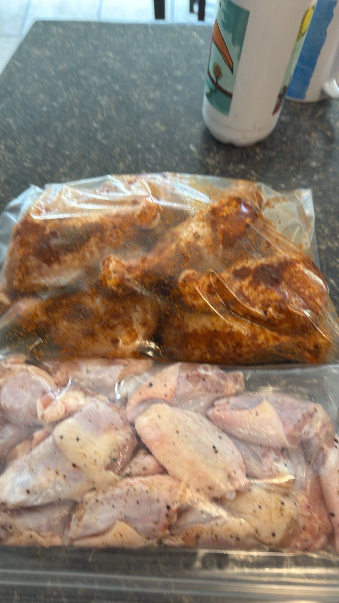 Raw chicken wings. One with a honey, brown sugar marinade and the other with a garlic, onion marinade.